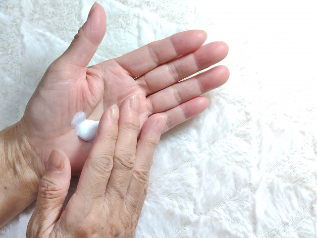 手にクリームを出している写真