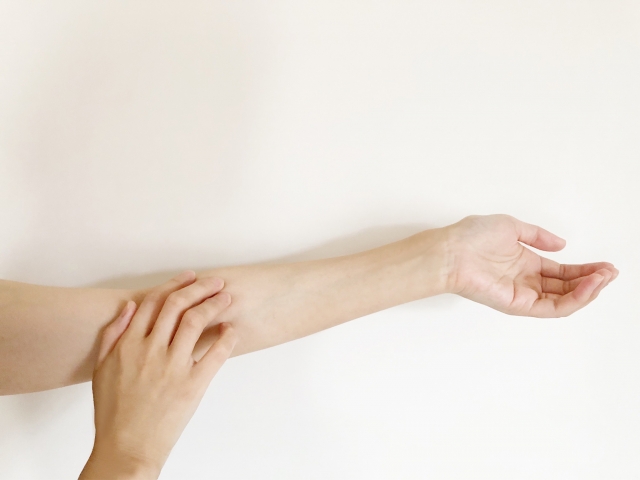 腕のかゆみで掻いている人の様子